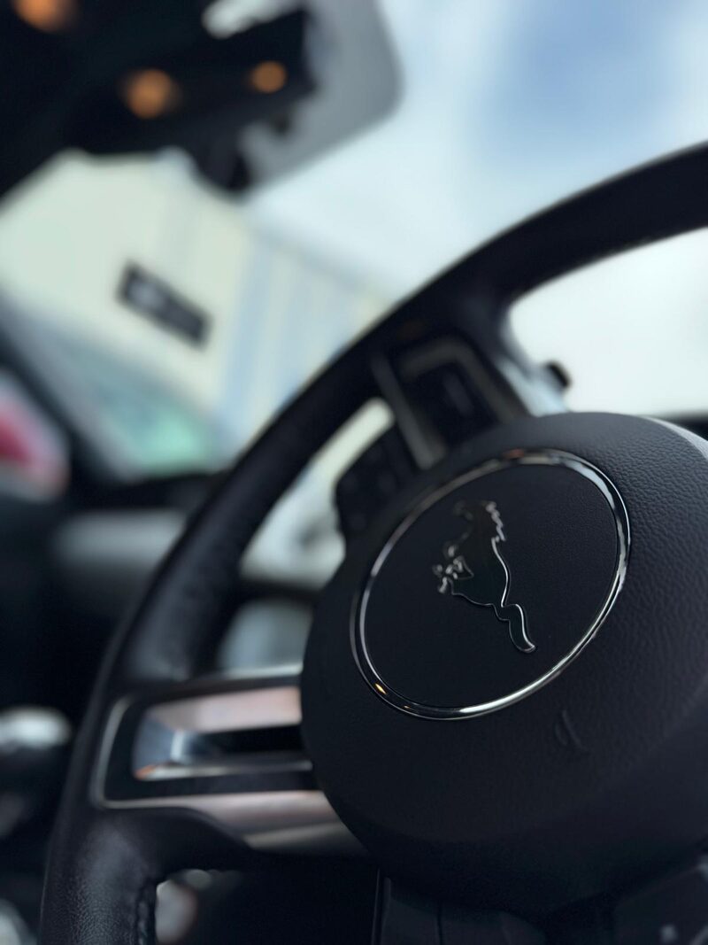 Ford Mustang steering wheel cleaned during an interior detail